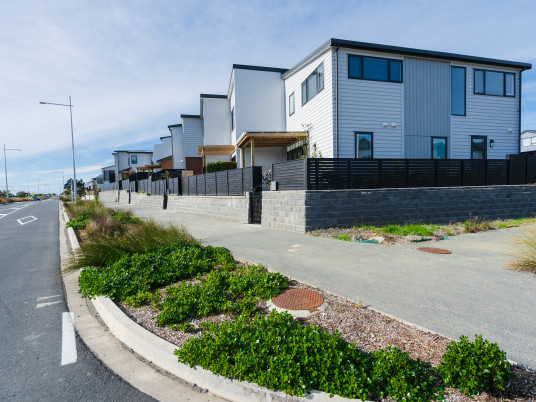 [image] a street with housing down one side